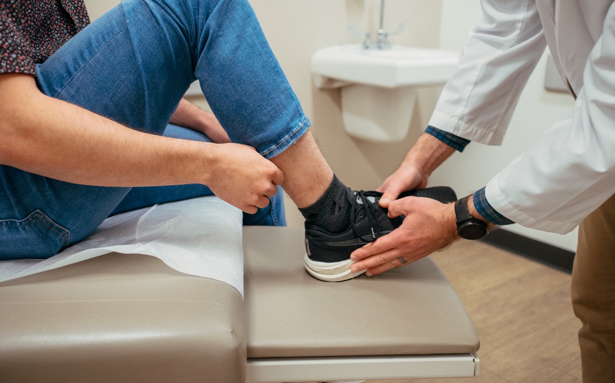 medical provider examining patient's ankle injury