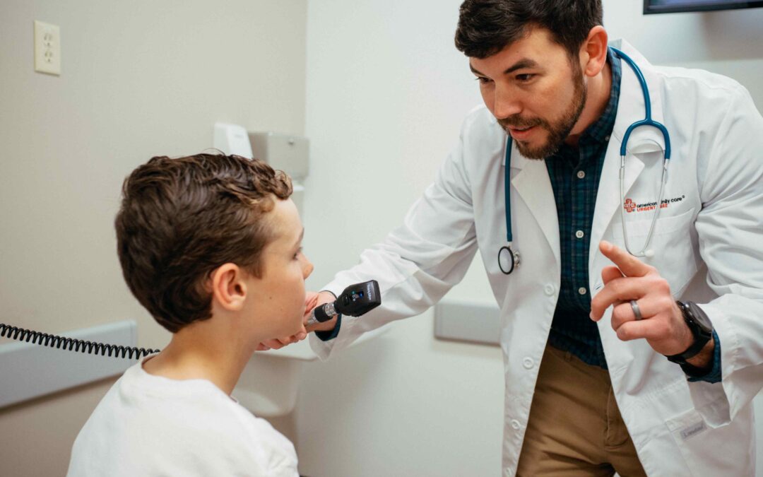 AFC medical provider examining pediatric patient for concussion in an examination room.